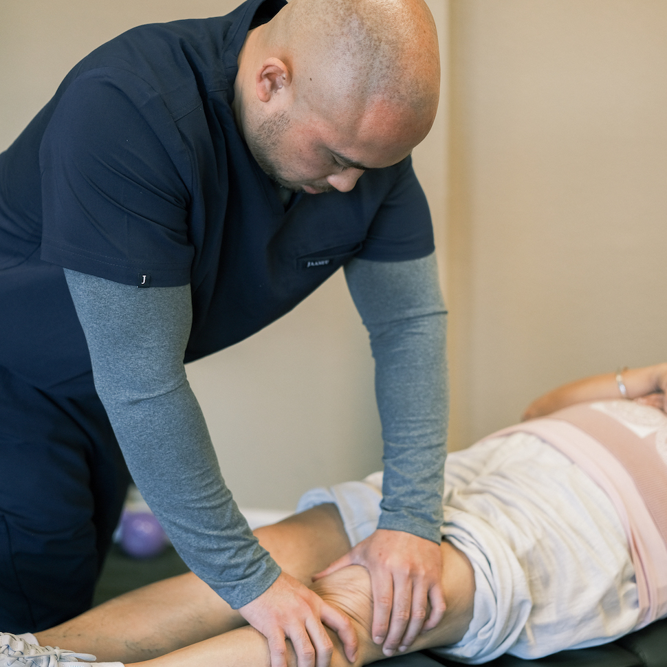 Dr. Jerald Chavez giving patient knee pain treatment